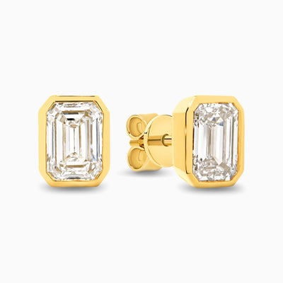Bezel set 2ct emerald cut lab grown diamond stud earrings in 18ct yellow gold