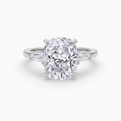 The Francis cushion cut lab grown diamond three stone engagement ring with tapered baguette side stones