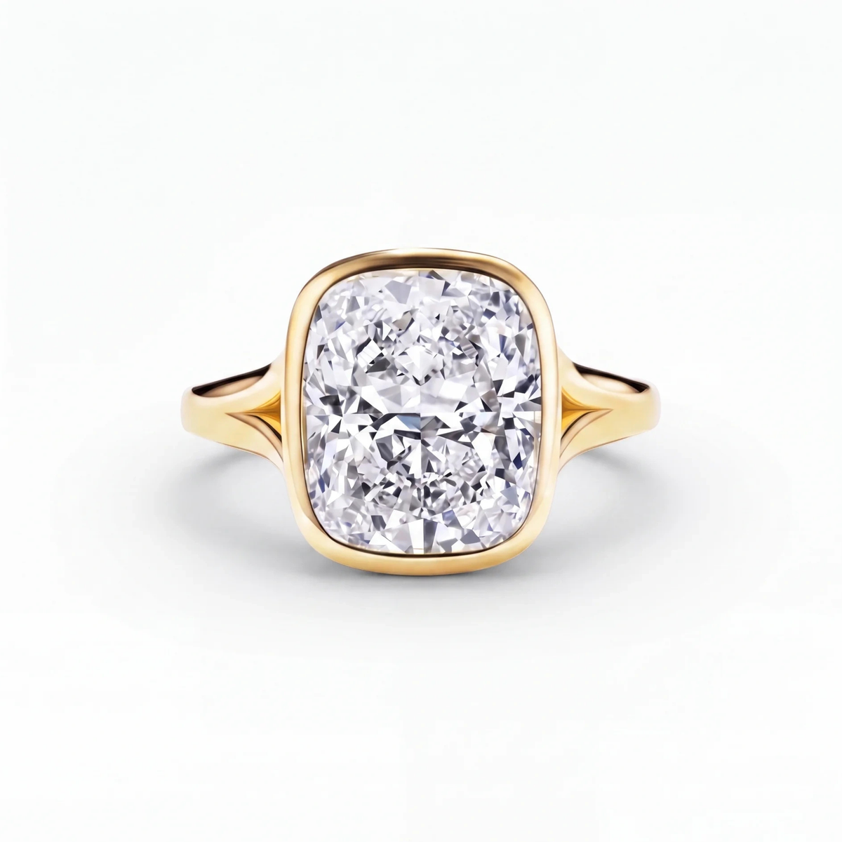 The Celleste bezel set split shank engagement ring in 18ct yellow gold, a 5.00 carat cushion cut lab-grown diamond held in a full bezel