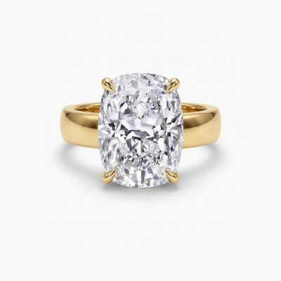The Maeve cushion solitaire engagement ring in 18ct yellow gold, a 6.00 carat cushion cut lab-grown diamond on a wide 5mm band