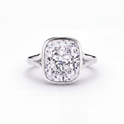 The Celleste bezel set split shank engagement ring in 18ct white gold and platinum, a 5.00 carat cushion cut lab-grown diamond held in a full bezel